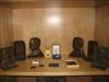 Group of bas-relief plaques and bookends depicting Theodore Roosevelt and his home.